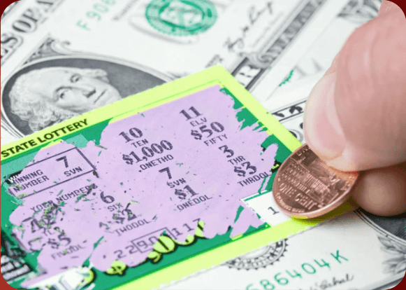 Player scratching a lottery ticket with a coin